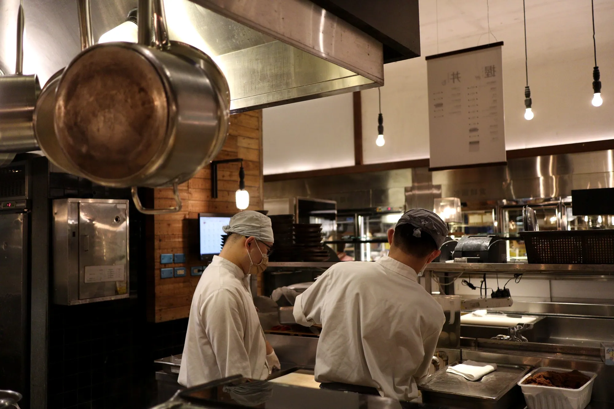 Chefs plating dishes in a professional restaurant kitchen