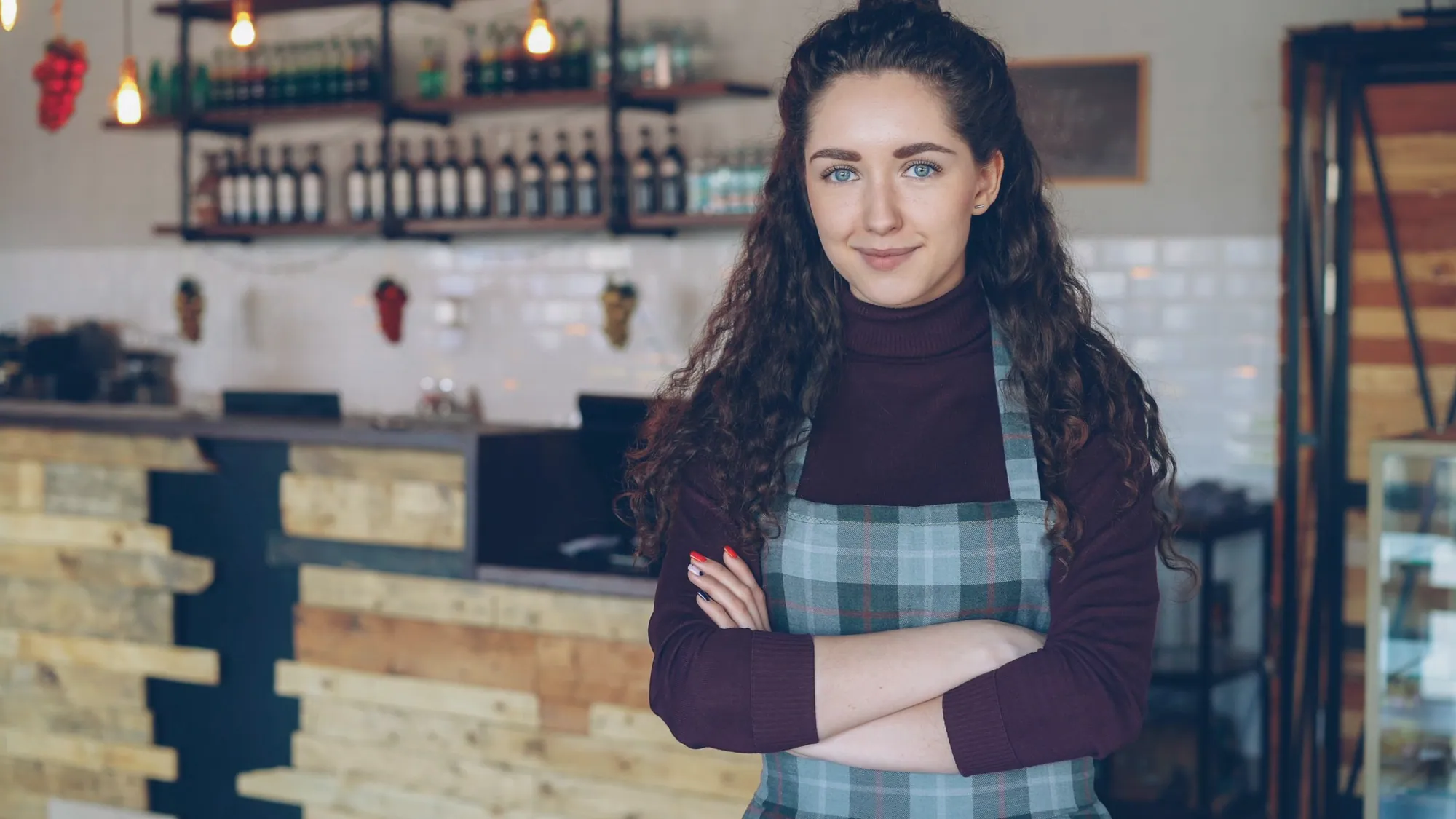 Independent cafe owner standing in her own dining room