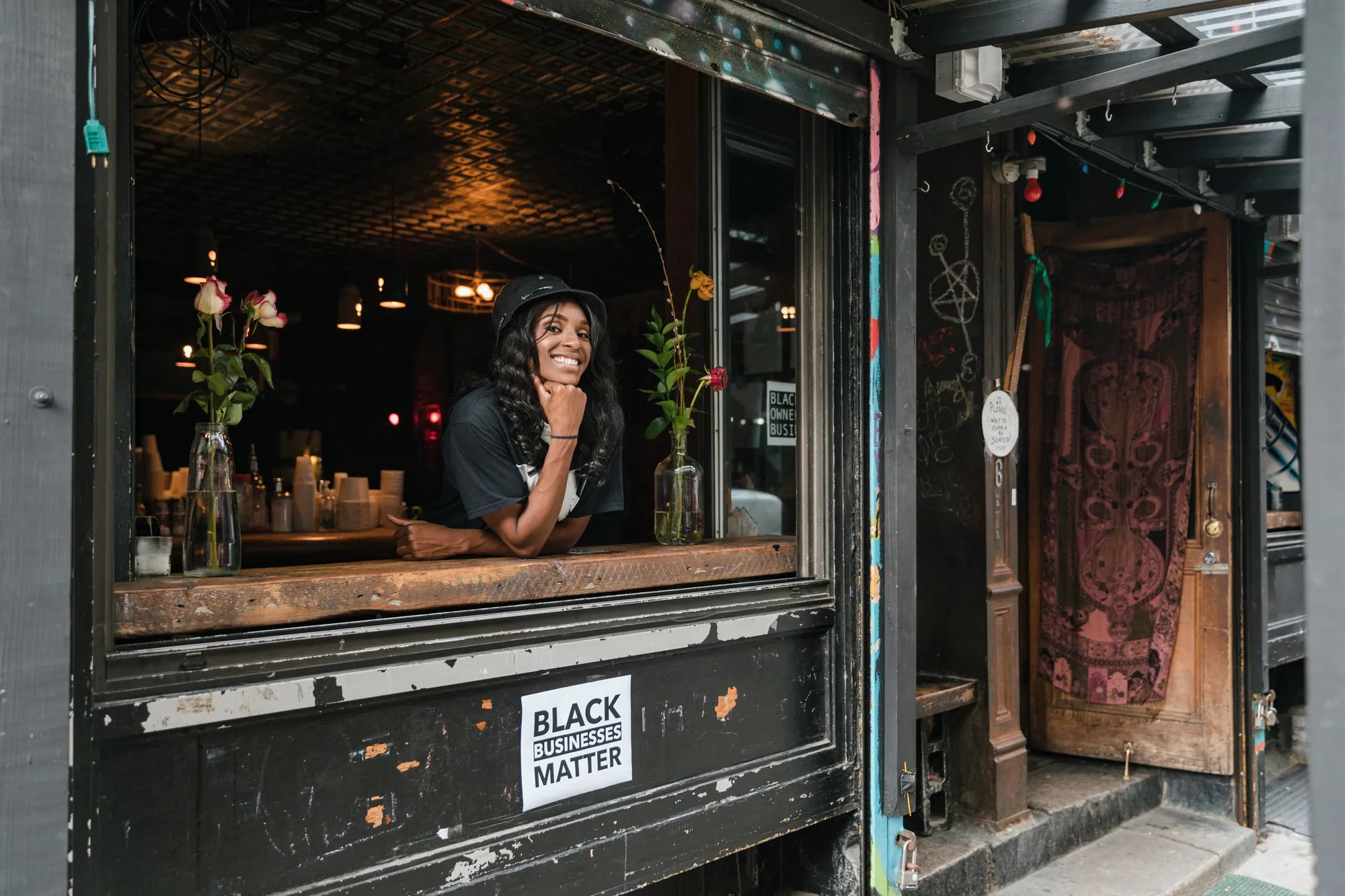 Cafe owner leaning out of her service window